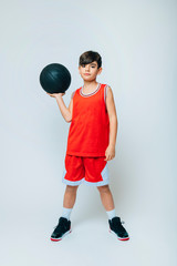 Portrait of boy with basketball on studio