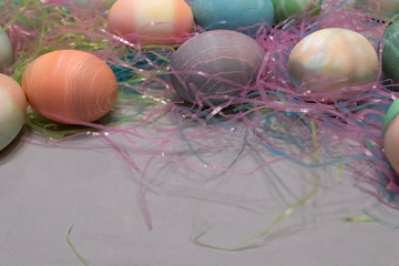 dyed easter eggs gathered together on a table