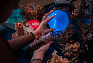 Tarot cards and crystal ball, candles, witch magic bottles . Wicca, esoteric, divination and occult background with vintage magic objects for mystic rituals