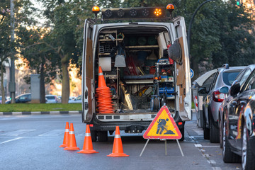 Valencia, Spain - January 16, 2019: Road maintenance van parked on a city street with cones.