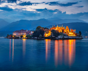 Wall Mural - Fantastic evening cityscape of Stresa town. Splendid summer night on Maggiore lake with Bella island on background, Province of Verbano-Cusio-Ossola, Italy, Europe. Traveling concept background.