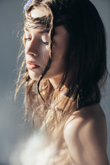 Wall Mural - beautiful naked boho girl with braids in hairstyle posing on grey with lens flares