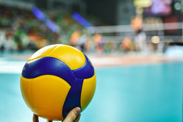 Volleyball ball with playing field in the background.