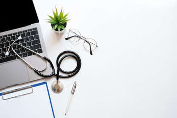 Work space medical technology and healthy concept on modern white table desk with stethoscope and laptop computer, supplies, Top view with copy space, Flat lay