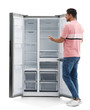 © New Africa - Man near empty refrigerator on white background