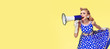 © vgstudio - Retro, vintage  and holiday sales concept picture- Woman holding megaphone, dressed in pin up style blue dress, over yellow background. Caucasian blond model - retro fashion.