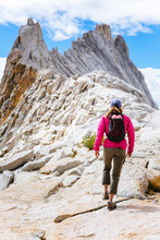 USA, California, Yosemite National Park, A Woman Is Hiking Near Matthes Crest, A Mile Long Fin Of Granite Rock.