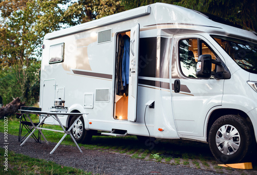 Cuadros en Lienzo White motor home parked in camping in the woods with the door open
