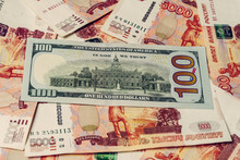 One Hundred Dollar Bill Lies On 5000 Russian Rubles, The Side Where The Hall Of Independence Is Depicted. 2019