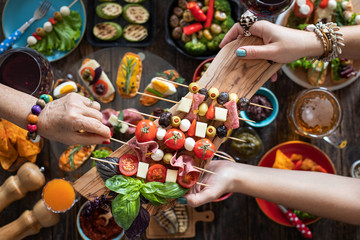 Wall Mural - Offering and serving tapas to many people hands