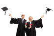 © Ljupco Smokovski - Elderly man and woman graduates throwing hats and holding diplomas