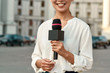 © Svitlana - TV reporter presenting the news outdoors. Journalism industry, live streaming concept.
