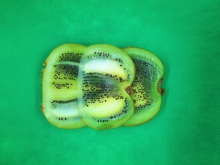  close-up of exotic fruit, green juicy ripe raw kiwi sliced ​​into slices on an abstract background