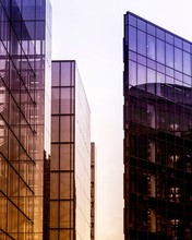 Vertical Shot Of High Rise  Buildings In A Glass Facade With Reflective Windows