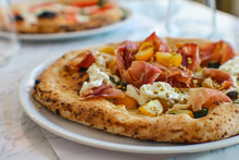 Detail Of Pizza With Corbarino Yellow Tomato, Black Casertano Pork Ham, Chopped Pistachio And Buffalo Stracciatella