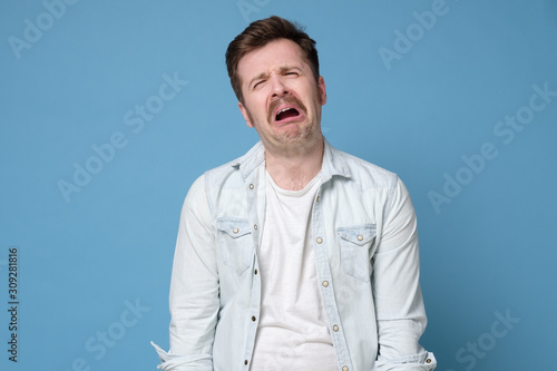 Funny caucasian man crying wipes tears losing his job. Poster Mural XXL