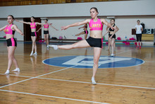 Dancers Shows Off Their Moves - Pirouette, Girls In Black And Pink Sportswear Train At The Gym, Sport Young Woman Rotates On One Leg, Cheerleader Dancer Doing Pirouette