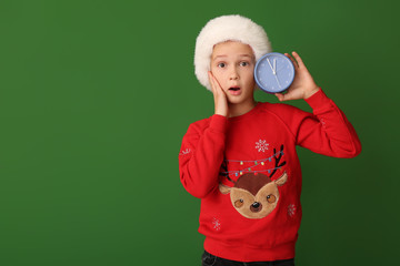 Sticker - Surprised little boy with alarm clock on color background. Christmas countdown concept