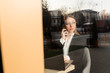 © Dumitru - a beautiful girl wearing in office clothes with sunglasses talking on the phone in the cafe