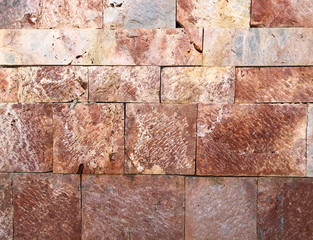 Pattern of decorative red stone wall background.Stone wall texture. random size stone wall.Background of stone wall.