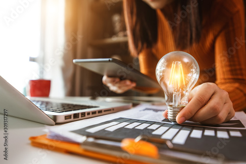 Fotomural business man using smartphone, tablet and holding light bulb, with idea with inn