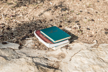 Religious books on Judaism lies on stones in the territory of the tomb of the prophet Samuel on Mount Joy near Jerusalem in Israel