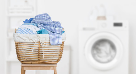 Wall Mural - Laundry basket on blurred background of modern washing machine