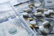 © MemoryMan - medicine pill on 100 dollar banknote background.Healthcare insurance and medical treatment cost concept