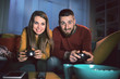 © StockPhotoPro - Happy couple playing video games together at home
