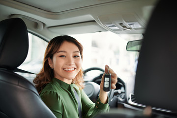 Young asian woman buying new car