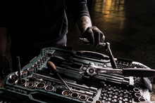 Detail Of The Hands Of A Mechanic Taking A Screwdriver From A Toolbox
