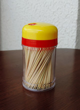 A Toothpick Container On The Wooden Table