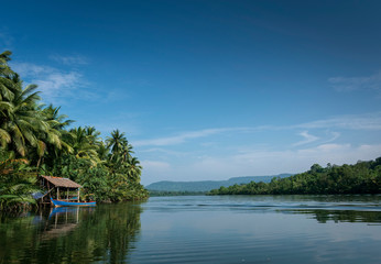 Wall Mural - boat and jungle hut on the tatai river in cambodia