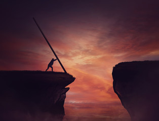 businessman pushing a long beam, creating an improvised bridge to cross the abyss obstacle. cover th