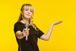 Presentation, public speech, conference, broadcasting, advertising. Cheerful young businesswoman, reporter, TV presenter holding microphone isolated bright yellow background.