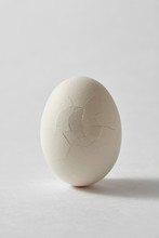 Organic White Broken Egg On A Gray Background With Space For Text. Healthy Product