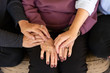© rzcreative/Stocksy - Three generations of women hold hands.