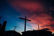 Cross Against Vivid Sunset In The Caribbean Islands