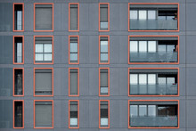 Orange Framed Windows In Gray Wall