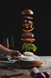 © Dejan Beokovic/Stocksy - Burger ingredients above plate
