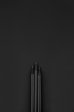 Three Black Pencils On A Black Background