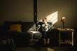 © LÈa Jones/Stocksy - boy eating breakfast on couch