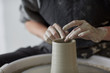 © Miquel Llonch/Stocksy - Female hands at work with the potter wheel