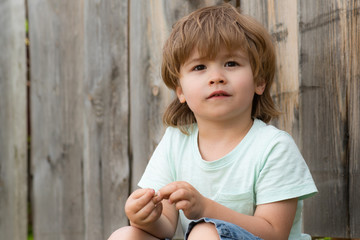 Wall Mural - Cute child looks with interest. Beautiful child portrait. Handsome boy 5 years of age.