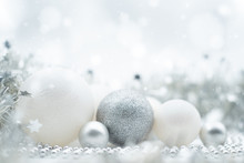 A Festive Design Of Silvery And White Christmas Ornaments Under A Winter Effect Bokeh And Snow Background With Copy Space
