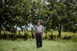 © guille Faingold/Stocksy - Elderly man standing in green countryside