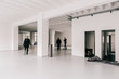 © visualspectrum/Stocksy - Empty Bright White Industrial Office and Event Space With Blurre