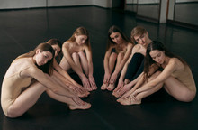 A Group Of Professional Choreographers Posing Sitting On The Floor