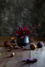Rustic Autumnal Table Setting With Flowers, Decorative Berries, Fruits And Nuts