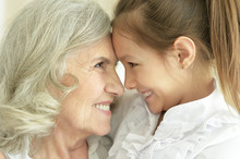 Portrait Of Grandmother With Her Cute Granddaughter Smiling
